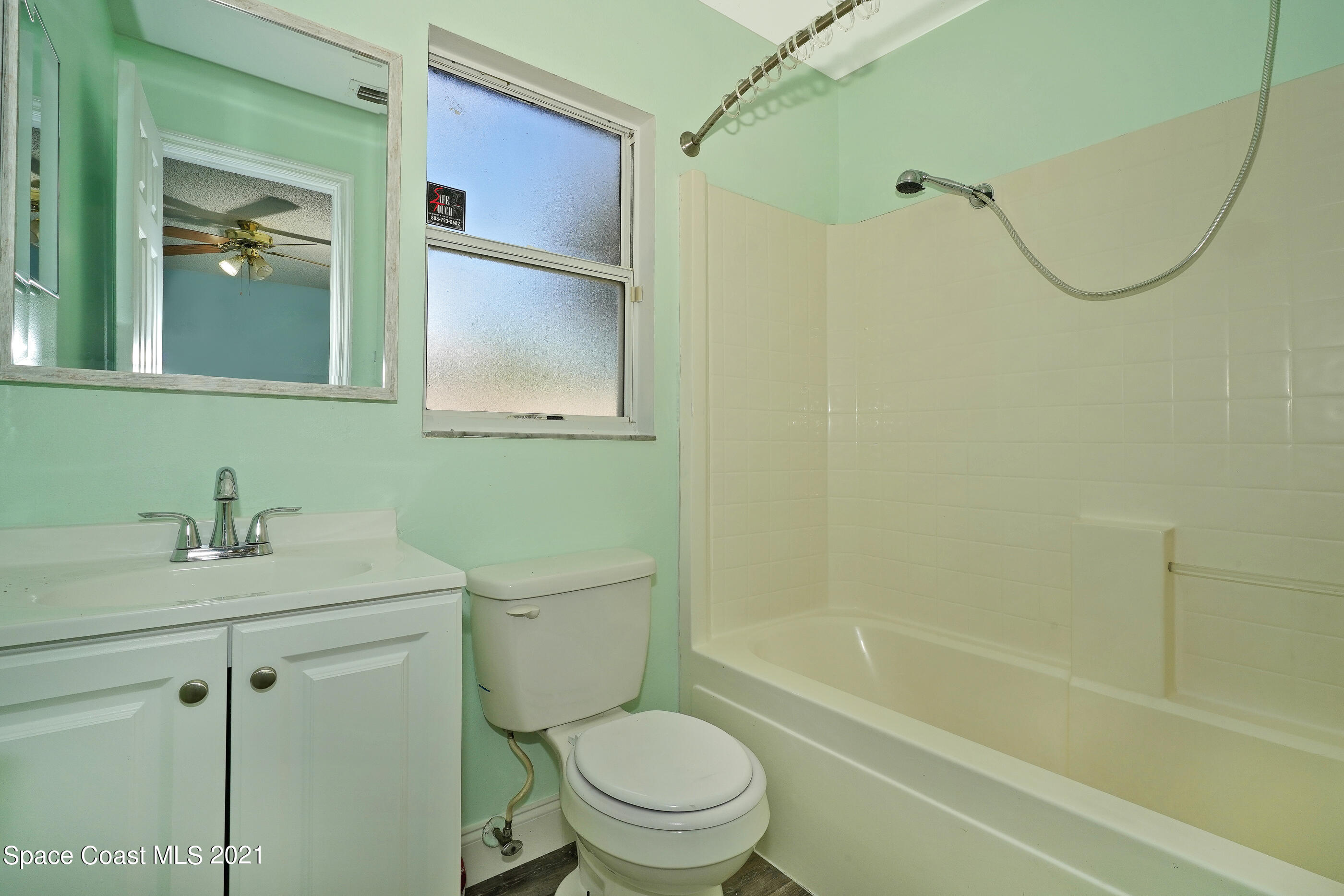 905 Macco Road Cocoa, FL 32927 - Photo 11 of 27 a bathroom with a sink a toilet and shower