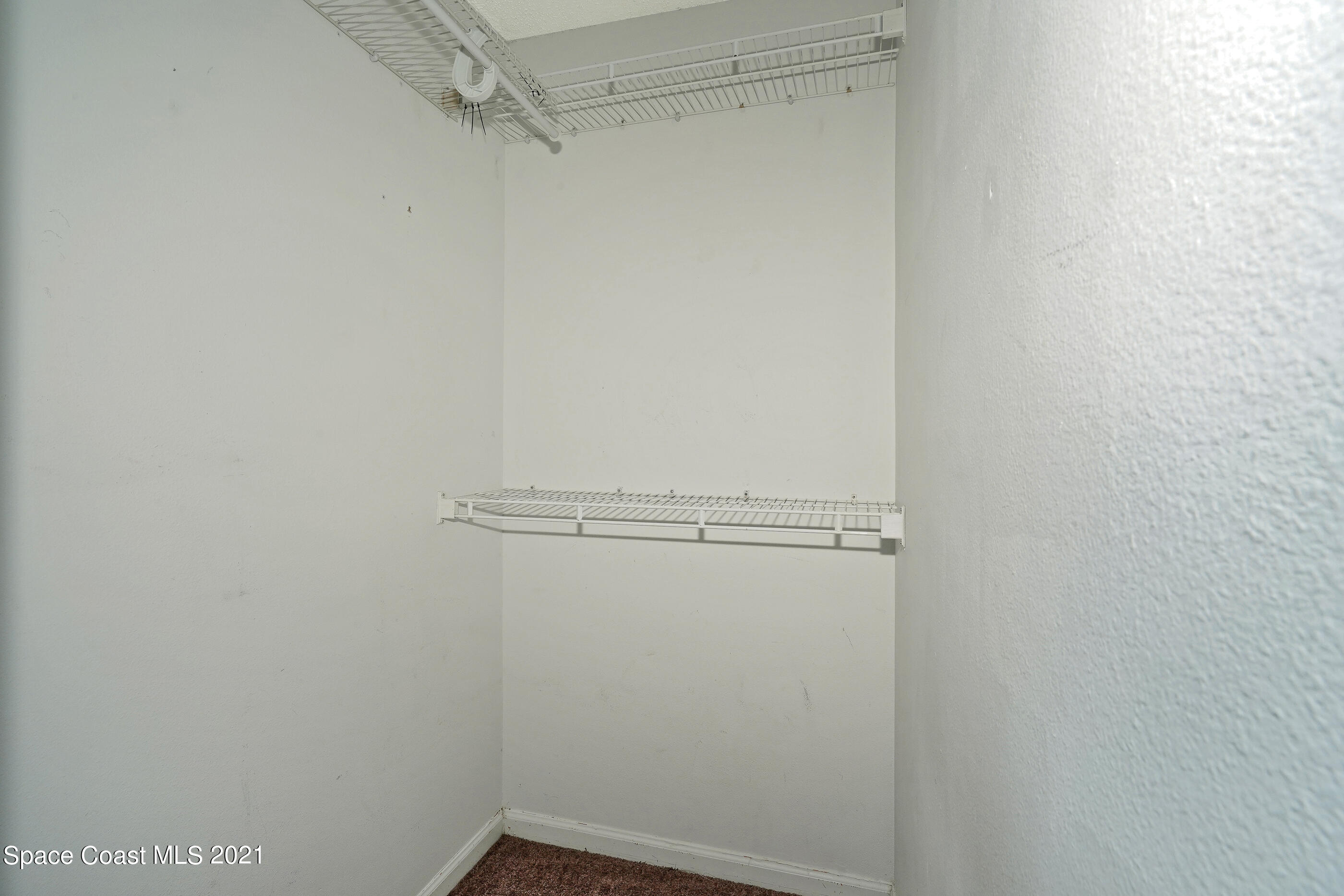 905 Macco Road Cocoa, FL 32927 - Photo 12 of 27 a view of a room with racks on the wall