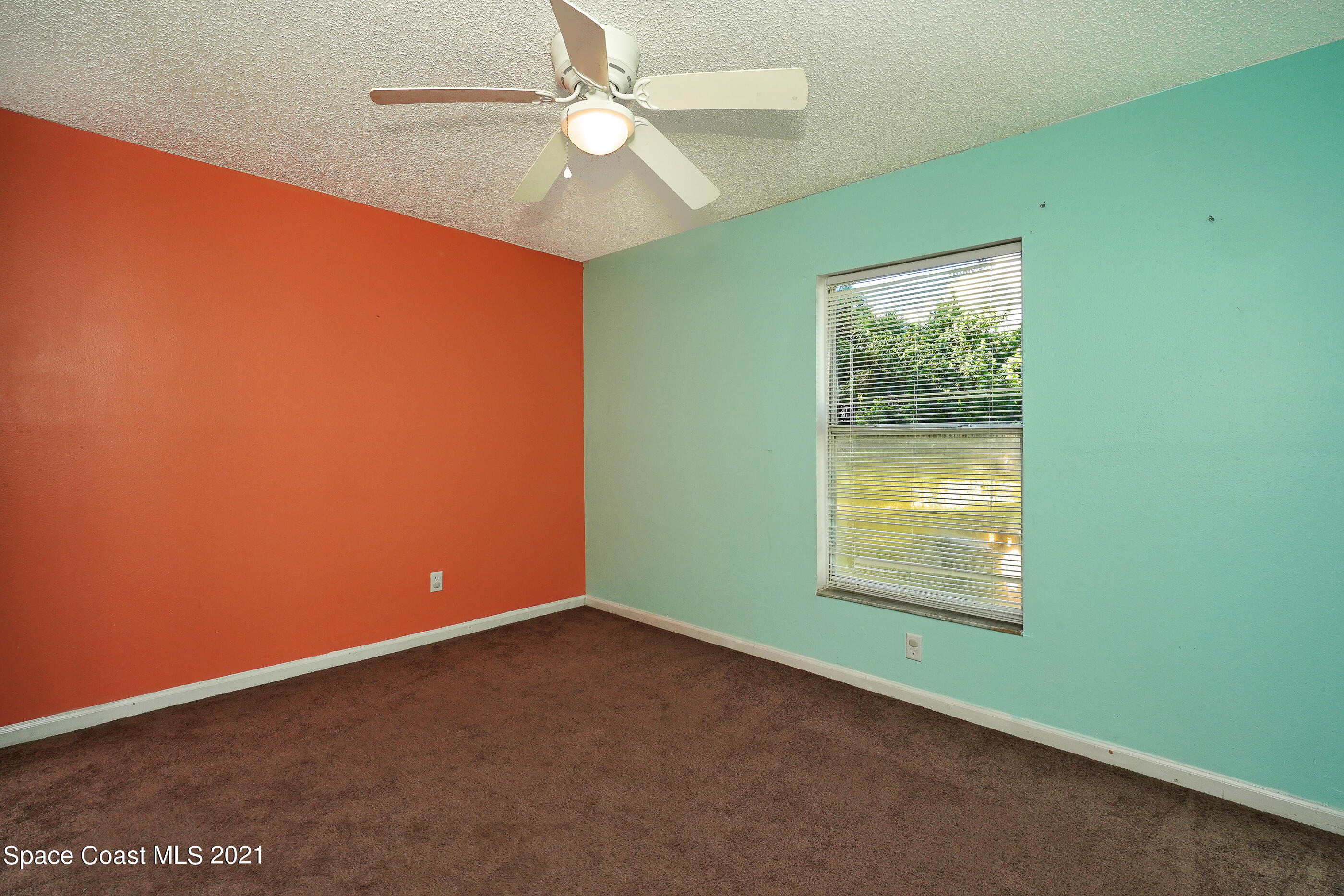 905 Macco Road Cocoa, FL 32927 - Photo 13 of 27 an empty room with a window and ceiling fan