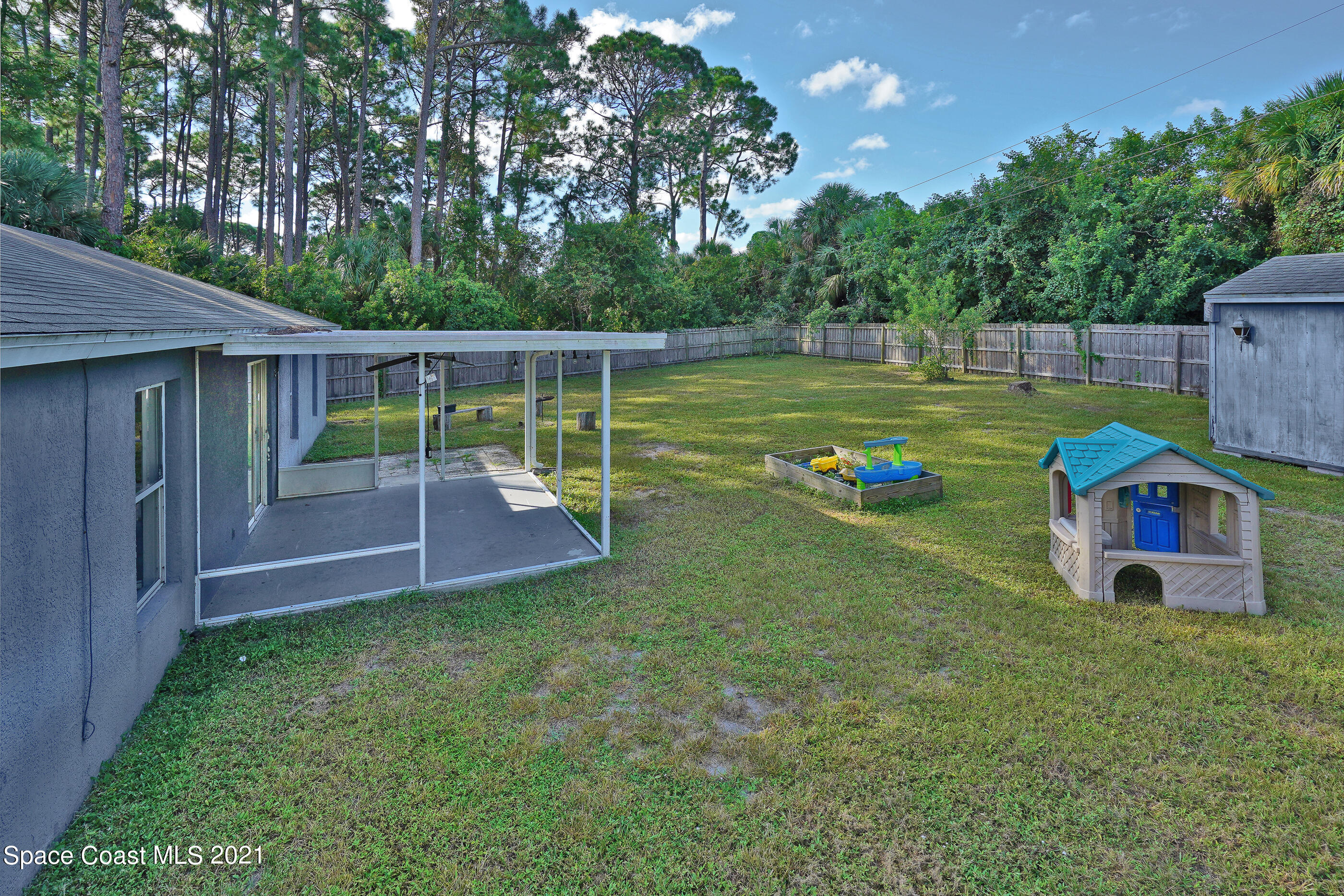 905 Macco Road Cocoa, FL 32927 - Photo 21 of 27 a view of a garden with a plants and large trees