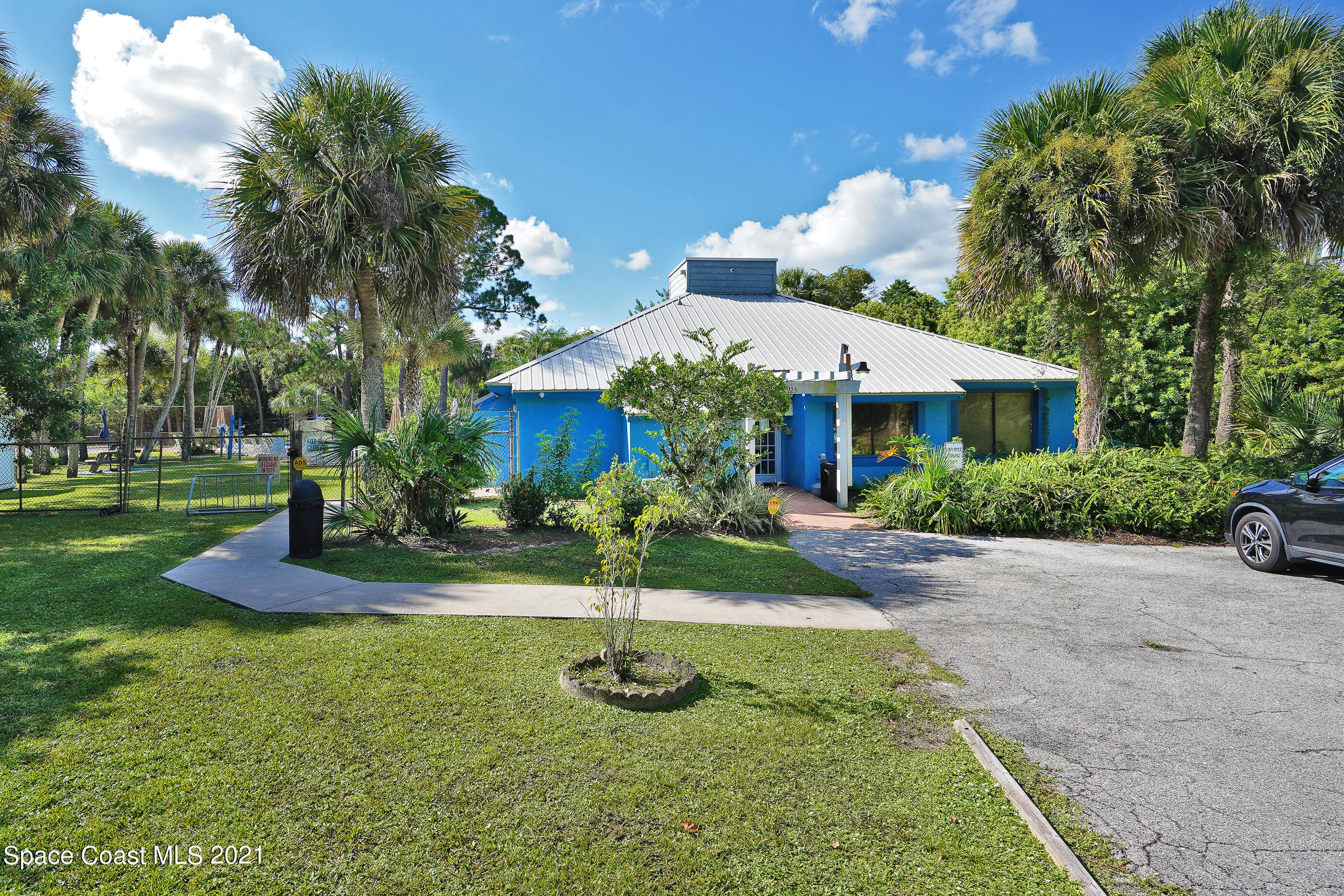 905 Macco Road Cocoa, FL 32927 - Photo 23 of 27 a front view of a house with garage and yard