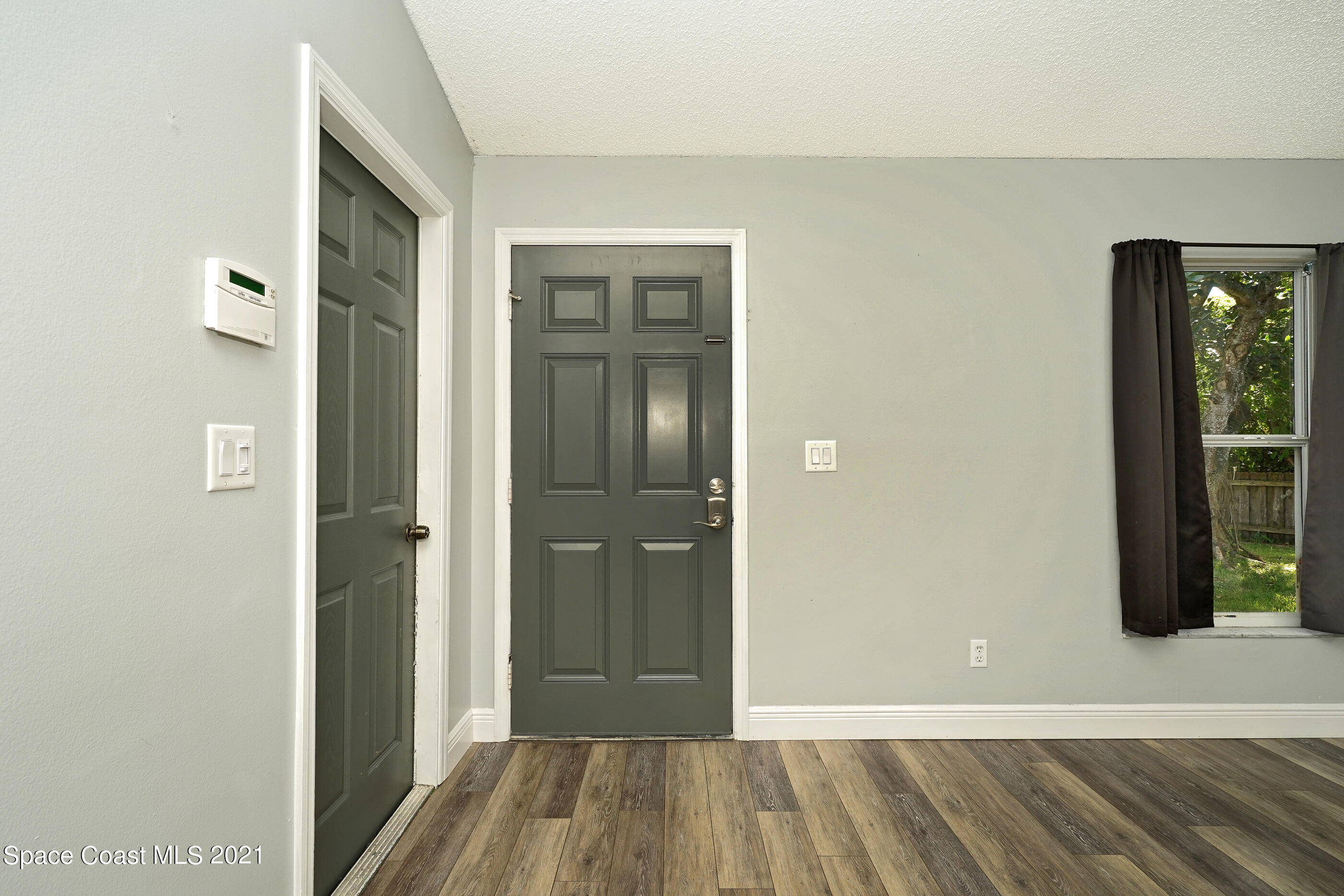905 Macco Road Cocoa, FL 32927 - Photo 4 of 27 a view of a hallway with wooden floor and staircase