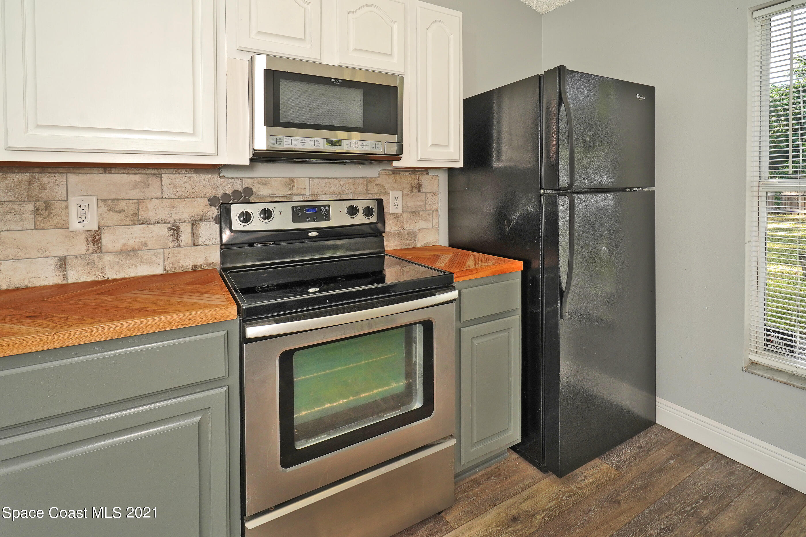 905 Macco Road Cocoa, FL 32927 - Photo 8 of 27 a kitchen with a stove and a microwave