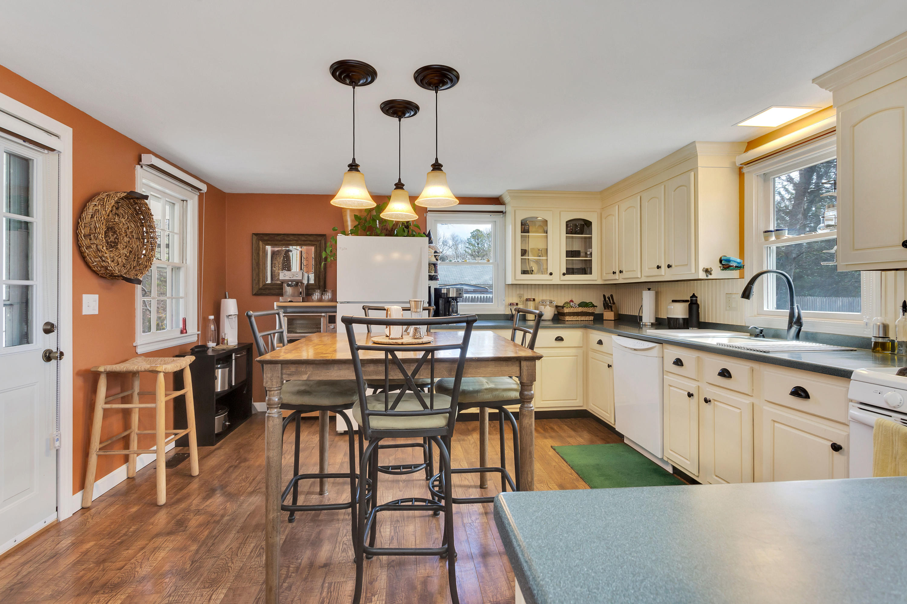 36 Scituate Road Mashpee, MA 02649 - Photo 12 of 36 a kitchen with stainless steel appliances granite countertop a stove a sink dishwasher a dining table and chairs with wooden floor