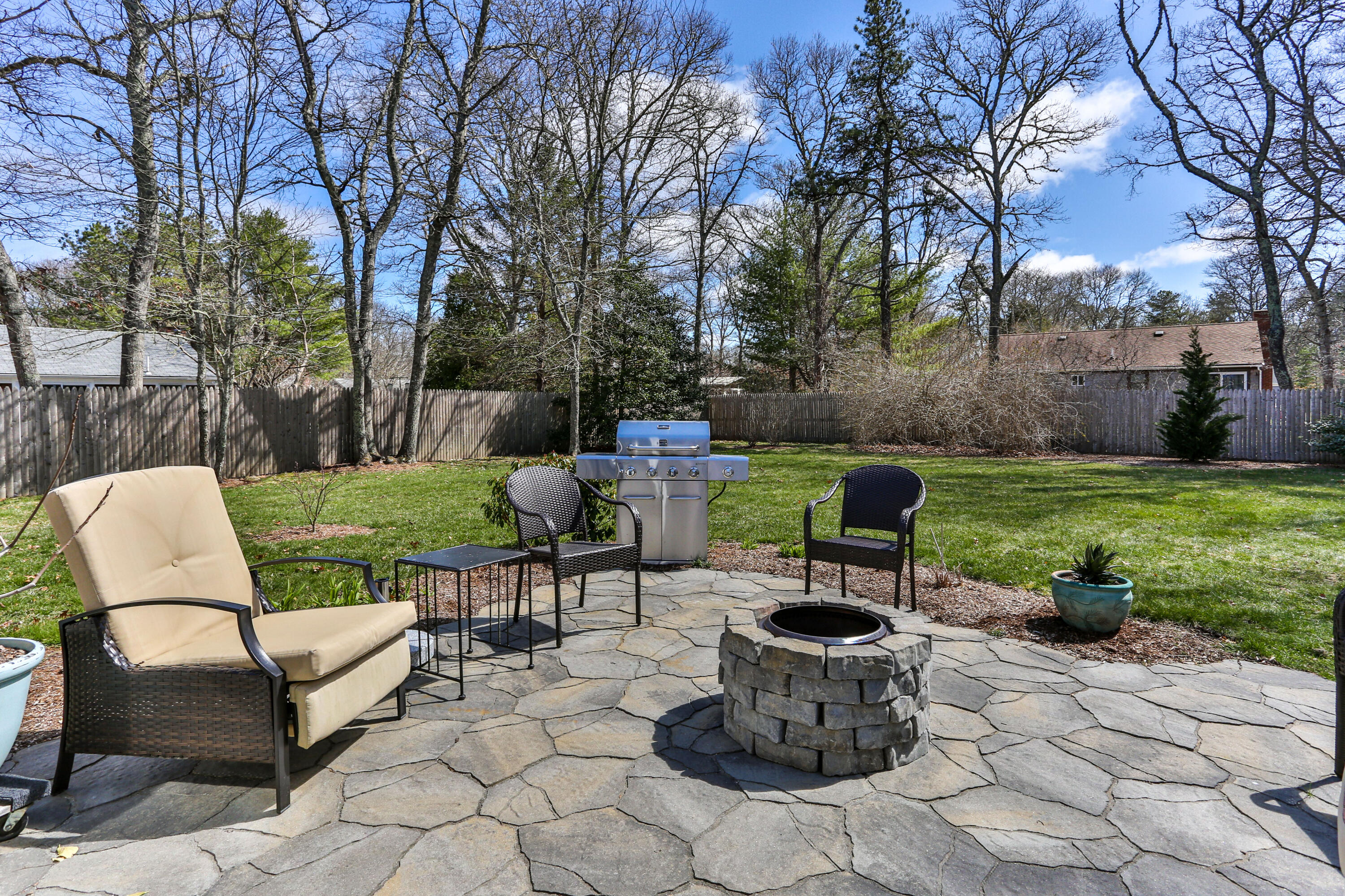 36 Scituate Road Mashpee, MA 02649 - Photo 27 of 36 a view of a backyard with sitting area and garden