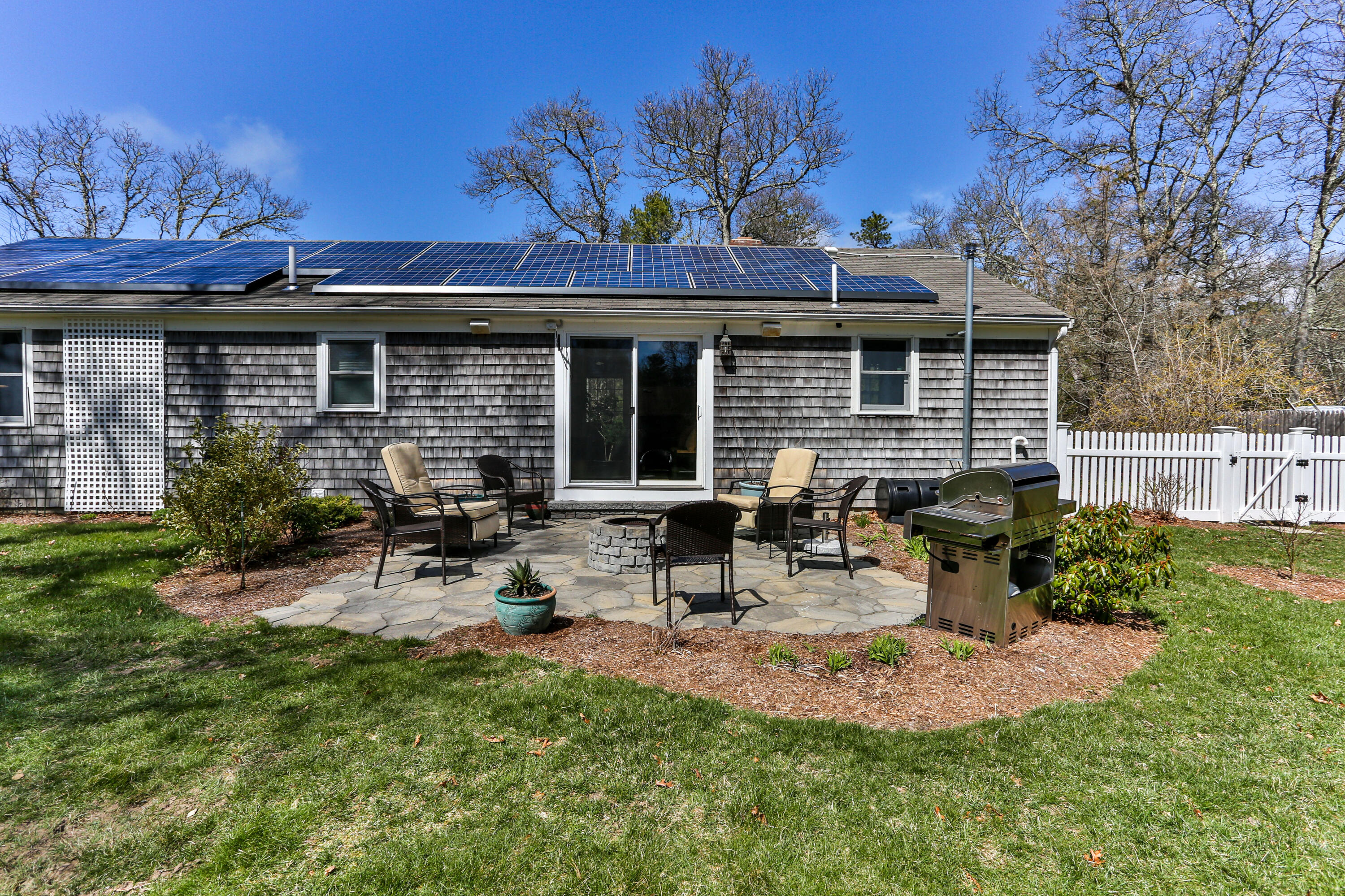 36 Scituate Road Mashpee, MA 02649 - Photo 29 of 36 a view of a patio with table and chairs with wooden fence