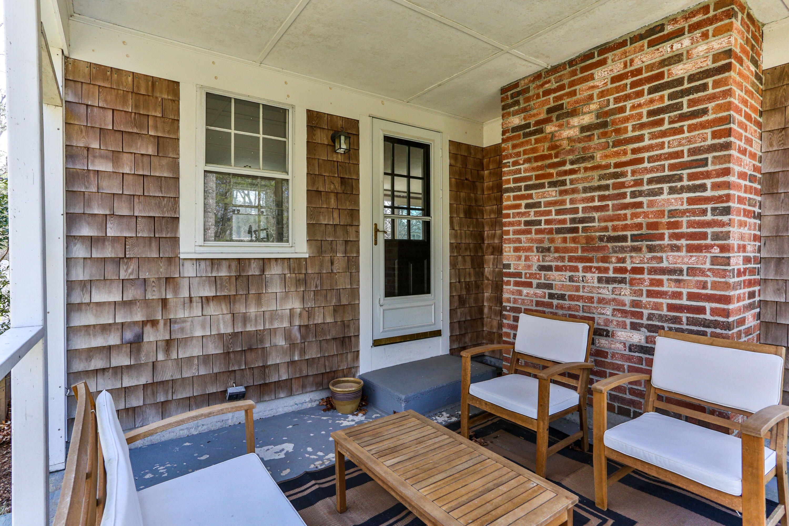36 Scituate Road Mashpee, MA 02649 - Photo 32 of 36 a balcony with a couch and wooden floor