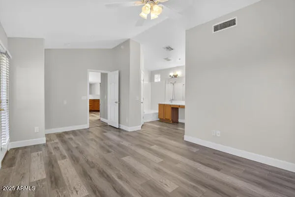 a view of an empty room and window with wooden floor