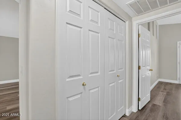 a view of a hallway with wooden floor