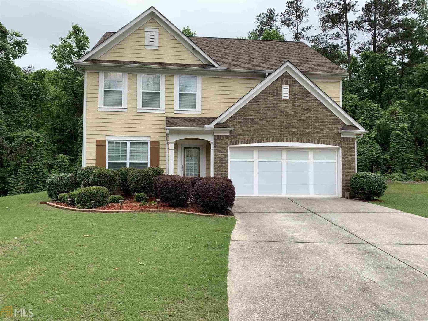 120 Redsage Ridge Atlanta, GA 30349 - Photo 1 of 1 a front view of a house with a yard and garage