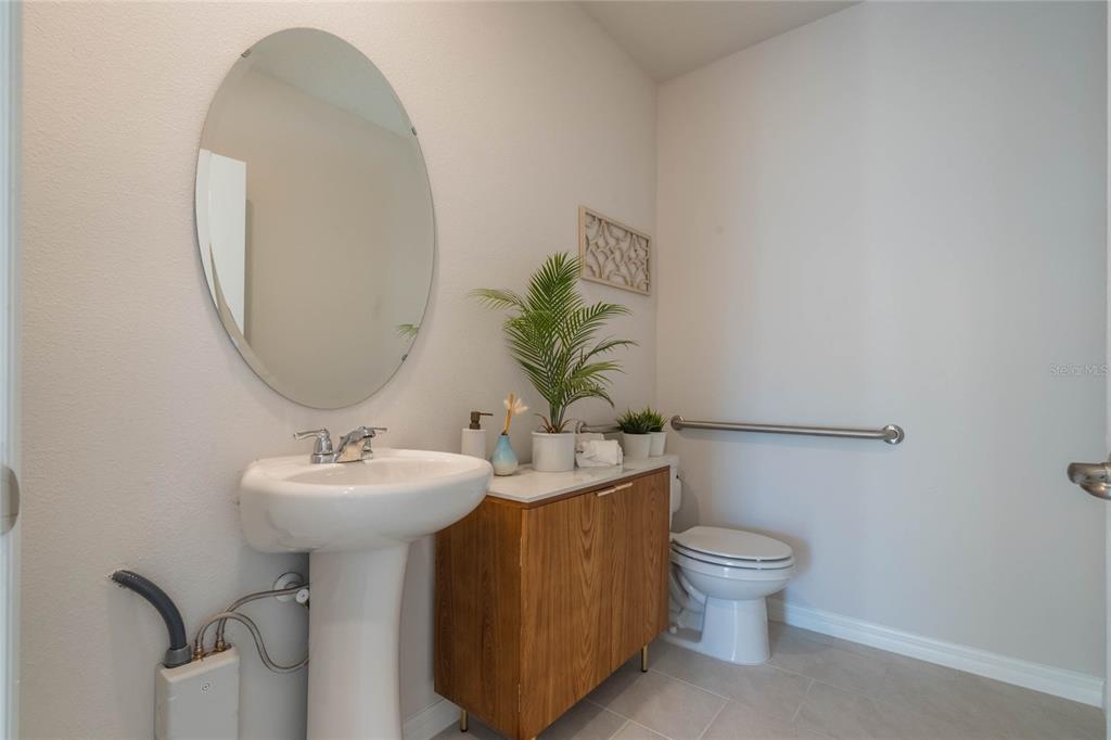 4201 Evernia Road Tavares, FL 32778 - Photo 15 of 25 a bathroom with a toilet sink and mirror