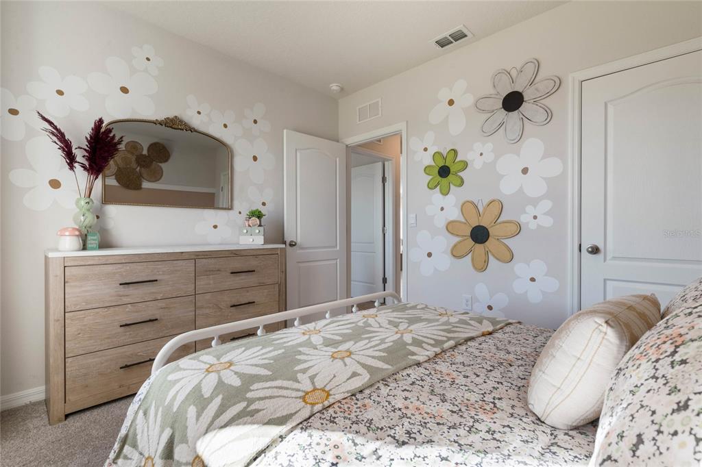 4201 Evernia Road Tavares, FL 32778 - Photo 17 of 25 a bedroom with a bed and a dresser