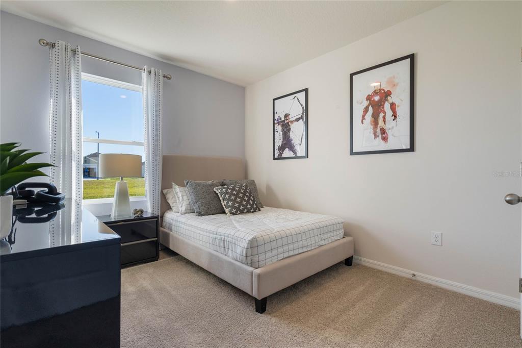 4201 Evernia Road Tavares, FL 32778 - Photo 18 of 25 a bedroom with a bed and a large window