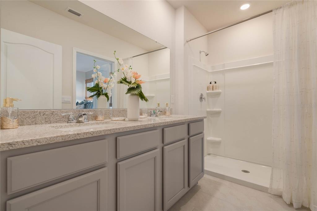 4201 Evernia Road Tavares, FL 32778 - Photo 23 of 25 a bathroom with a sink and a mirror
