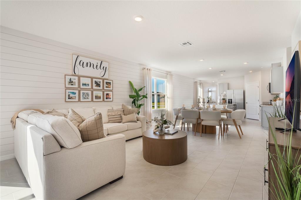 4201 Evernia Road Tavares, FL 32778 - Photo 7 of 25 a living room with furniture and a potted plant