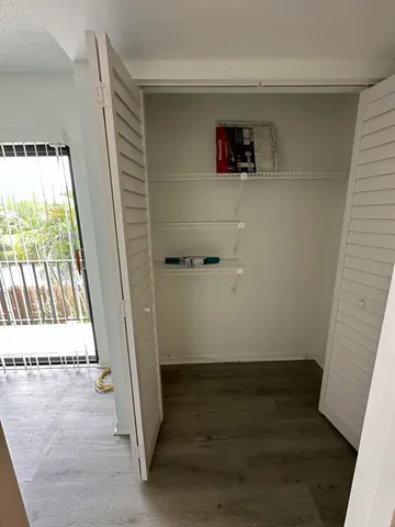 an empty room with wooden floor and a window