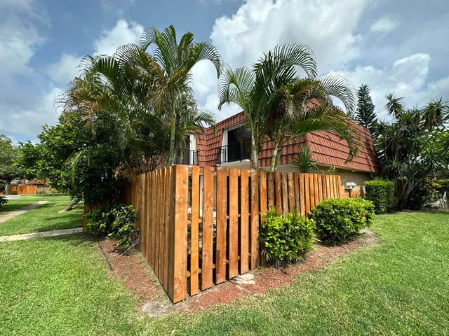 a view of a house with a small yard and plants