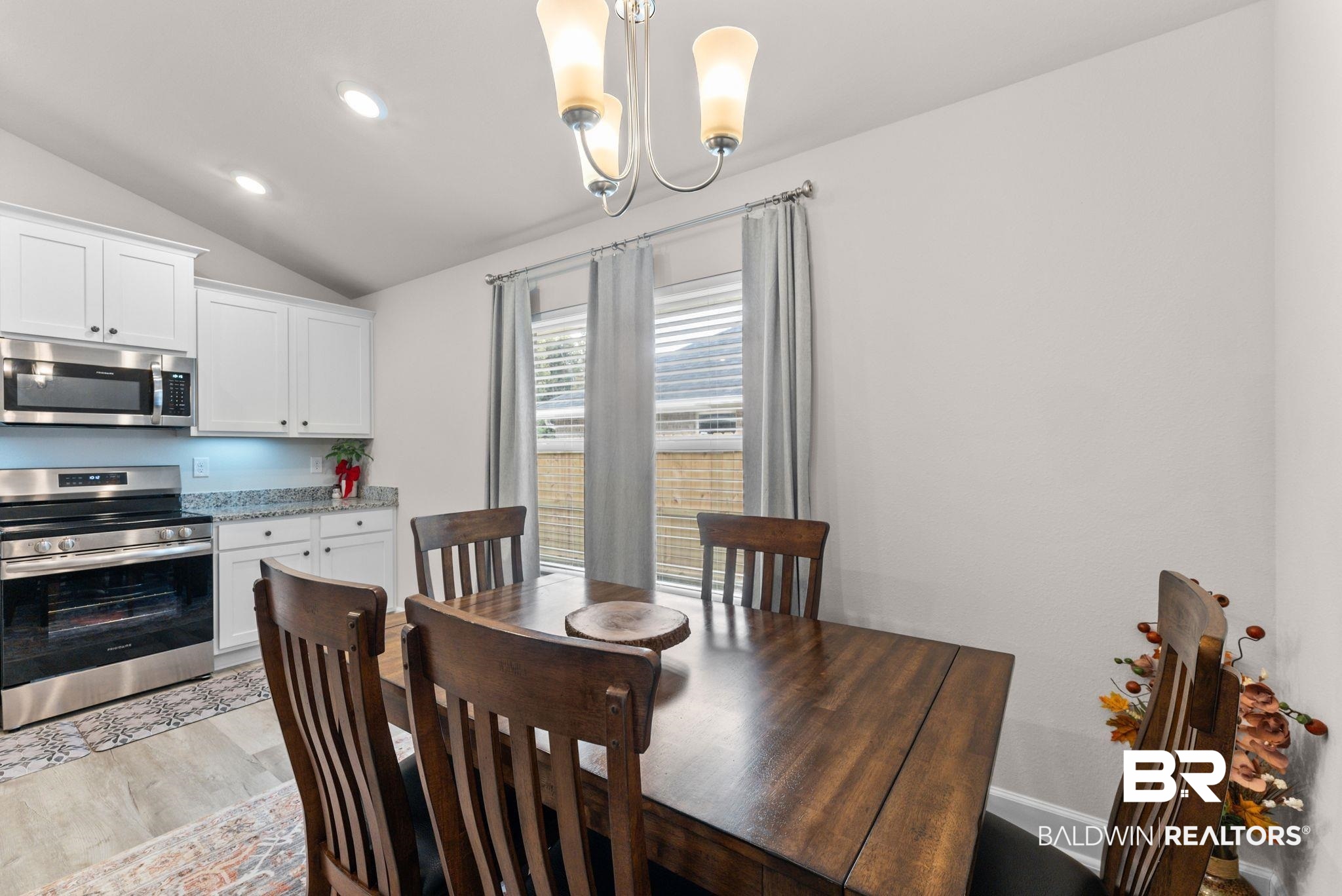 692 Mayflower Drive Foley, AL 36535 - Photo 14 of 40 Dining space featuring vaulted ceiling, light wood-style floors, and suspended lighting