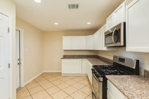 a kitchen with stainless steel appliances granite countertop a stove and a sink