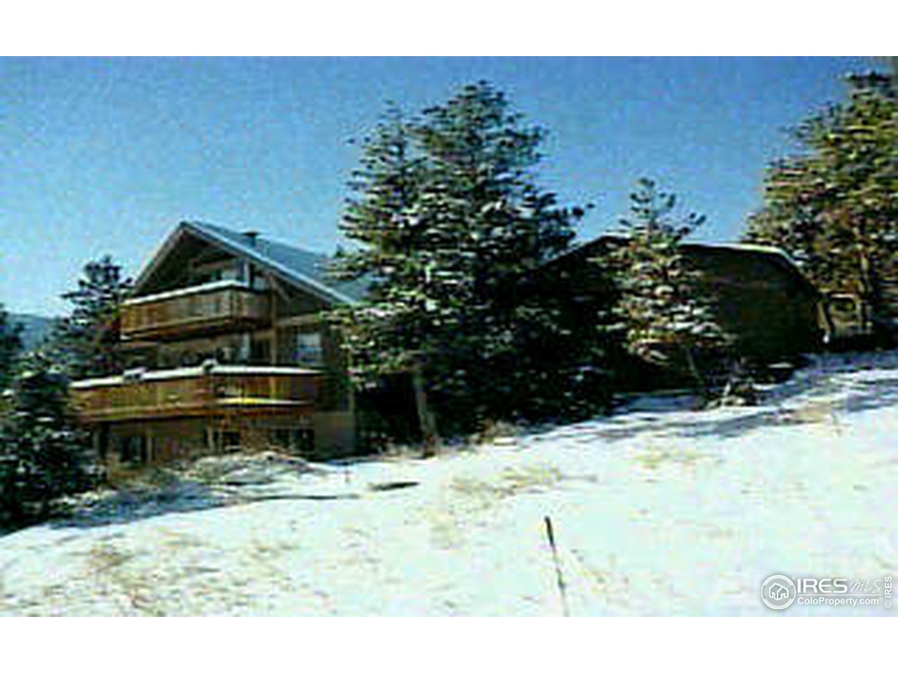 a view of a house with a yard covered in snow