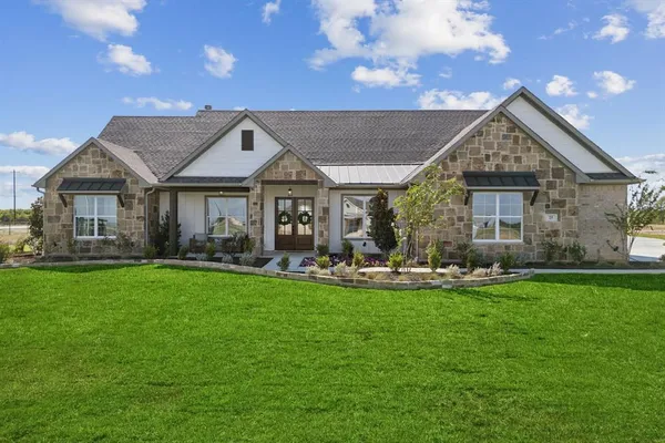a front view of house with yard and outdoor seating