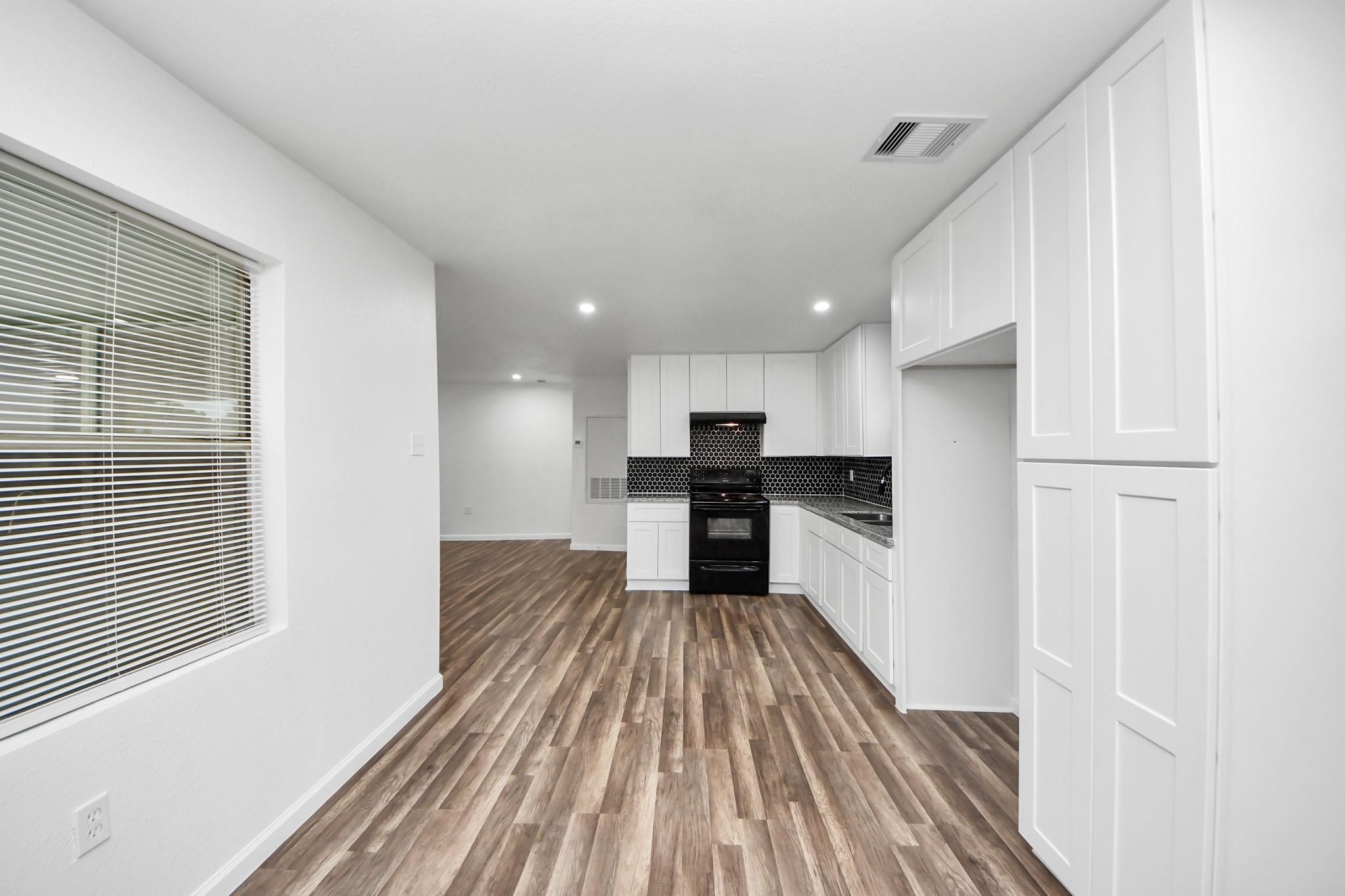 207 East Defee Avenue Baytown, TX 77520 - Photo 17 of 36 a view of kitchen with wooden floor electronic appliances and window