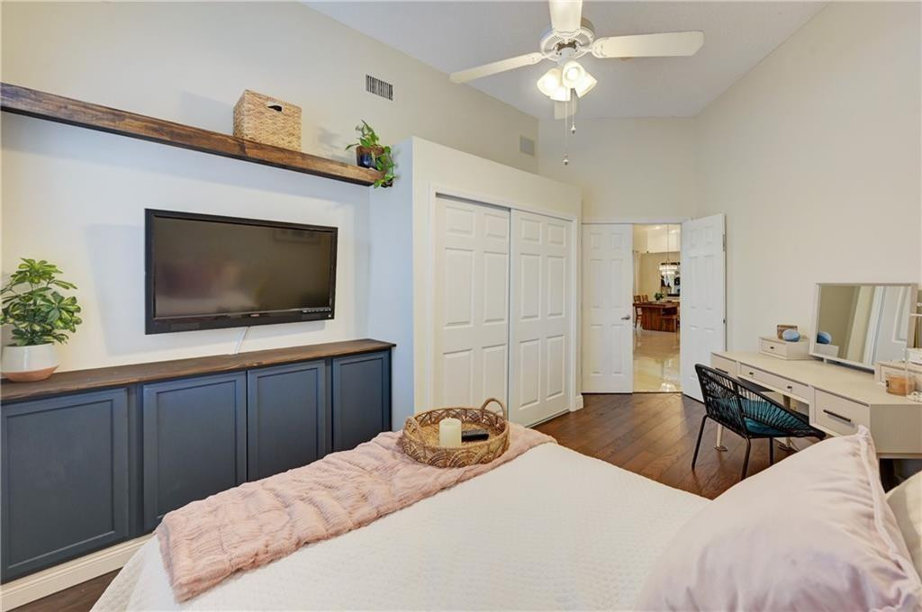8171 Hampton Wood Drive Boca Raton, FL 33433 - Photo 22 of 56 a bedroom with a bed and a flat screen tv