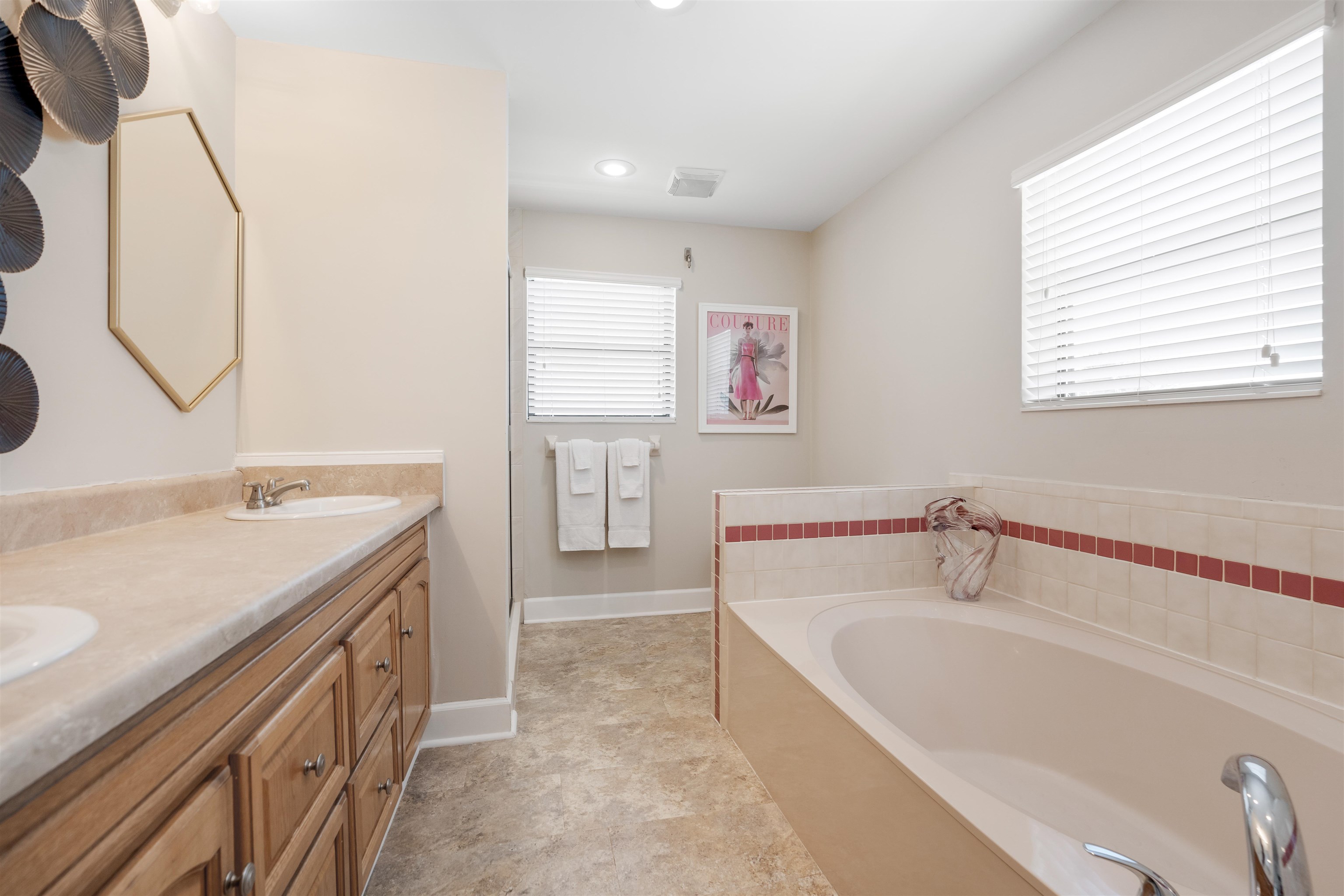 5424 Atlantic View St. Augustine, FL 32080 - Photo 28 of 42 a bathroom with a tub sink and mirror