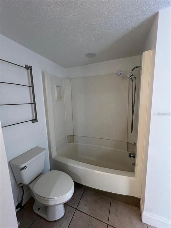 2220 Burnway Road, Unit 2220 Haines City, FL 33844 - Photo 6 of 16 a bathroom with a toilet and a shower