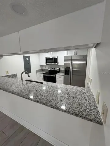 a view of entryway with kitchen