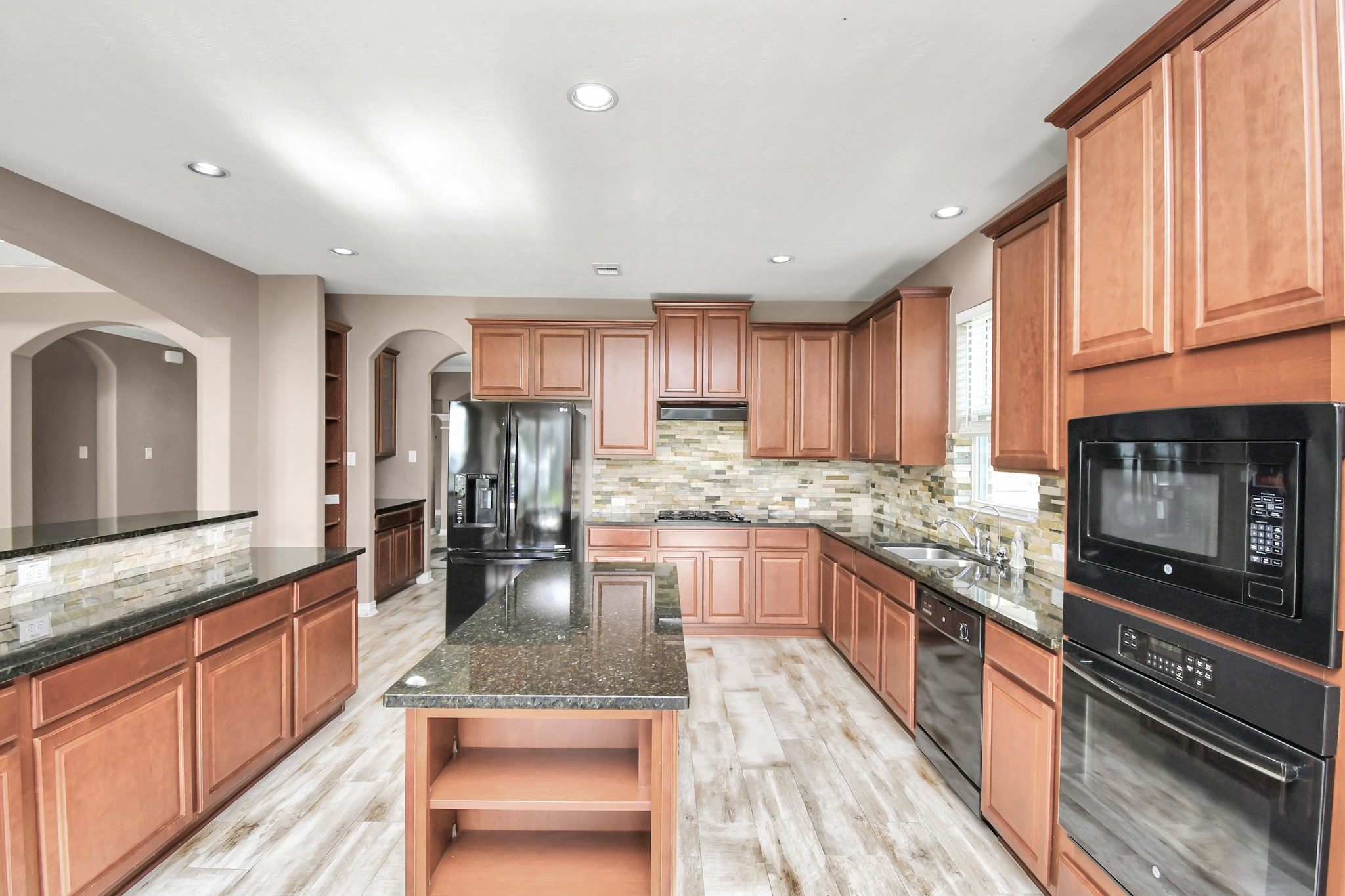 9511 Emerald Lakes Drive Rosharon, TX 77583 - Photo 12 of 38 a kitchen with stainless steel appliances granite countertop sink stove refrigerator and cabinets
