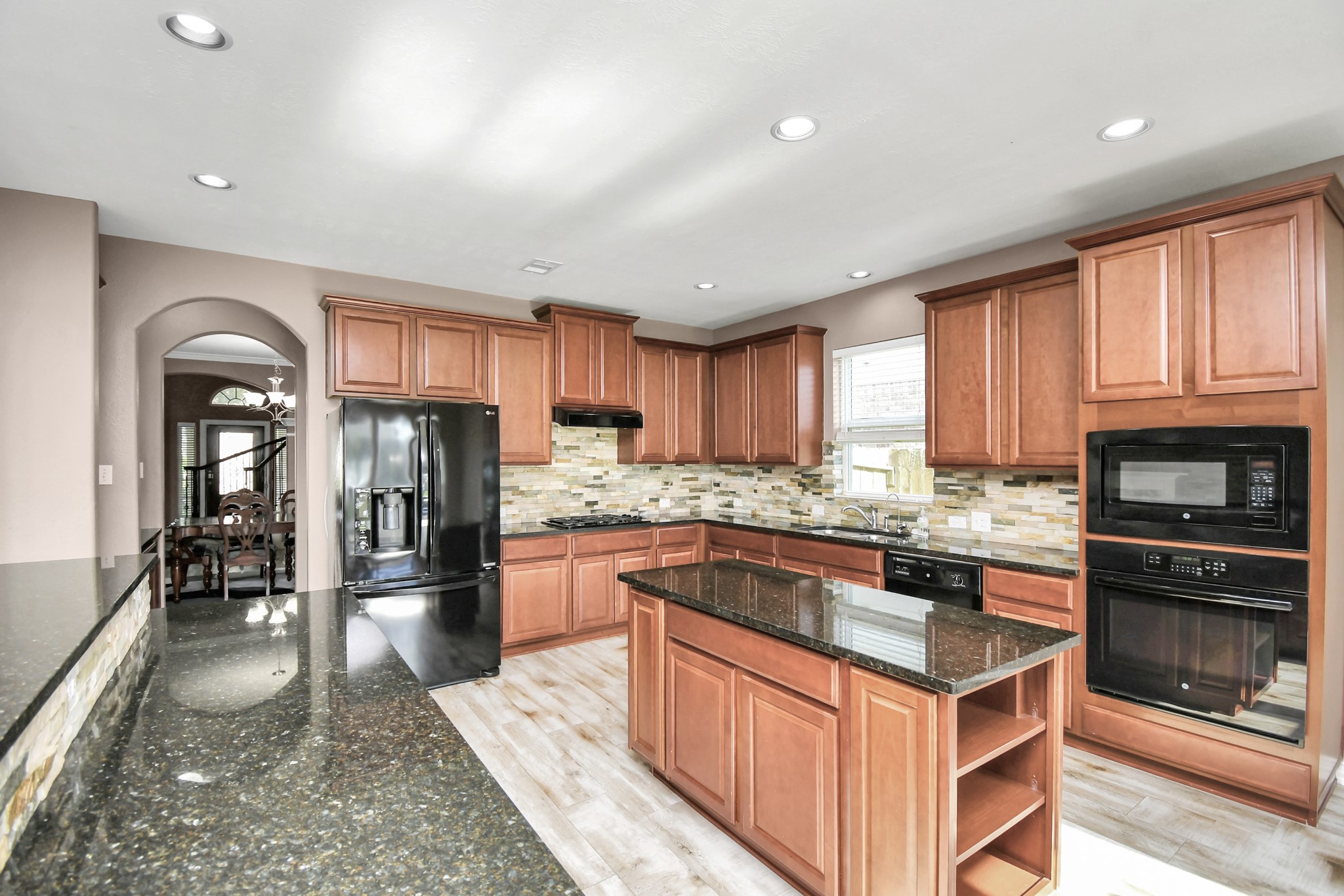 9511 Emerald Lakes Drive Rosharon, TX 77583 - Photo 13 of 38 a kitchen with stainless steel appliances granite countertop a stove refrigerator sink and cabinets