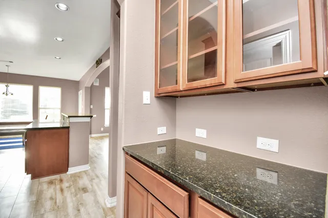 a kitchen with stainless steel appliances granite countertop a sink and a granite counter tops