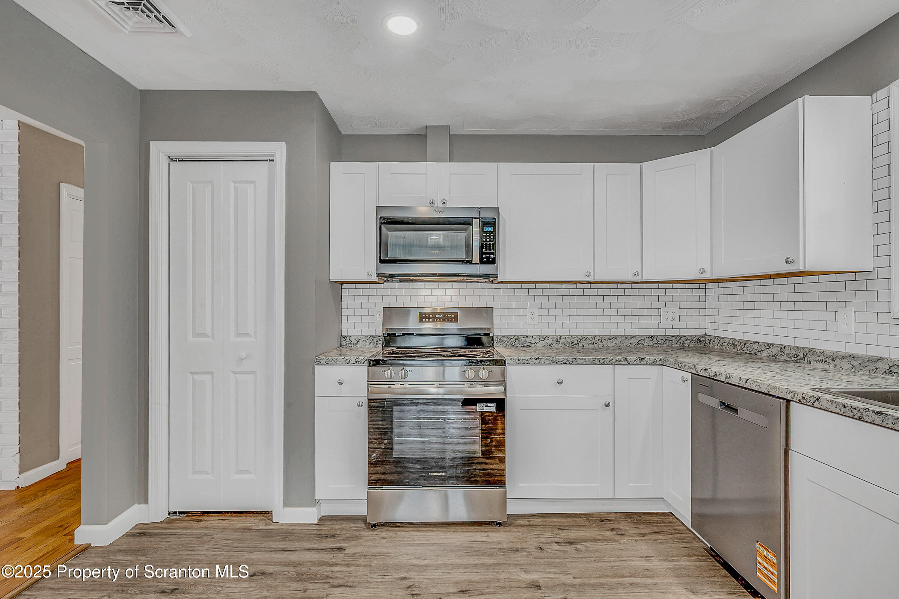 206 Gardner Street Moscow, PA 18444 - Photo 14 of 50 a kitchen with stainless steel appliances granite countertop a stove and a sink