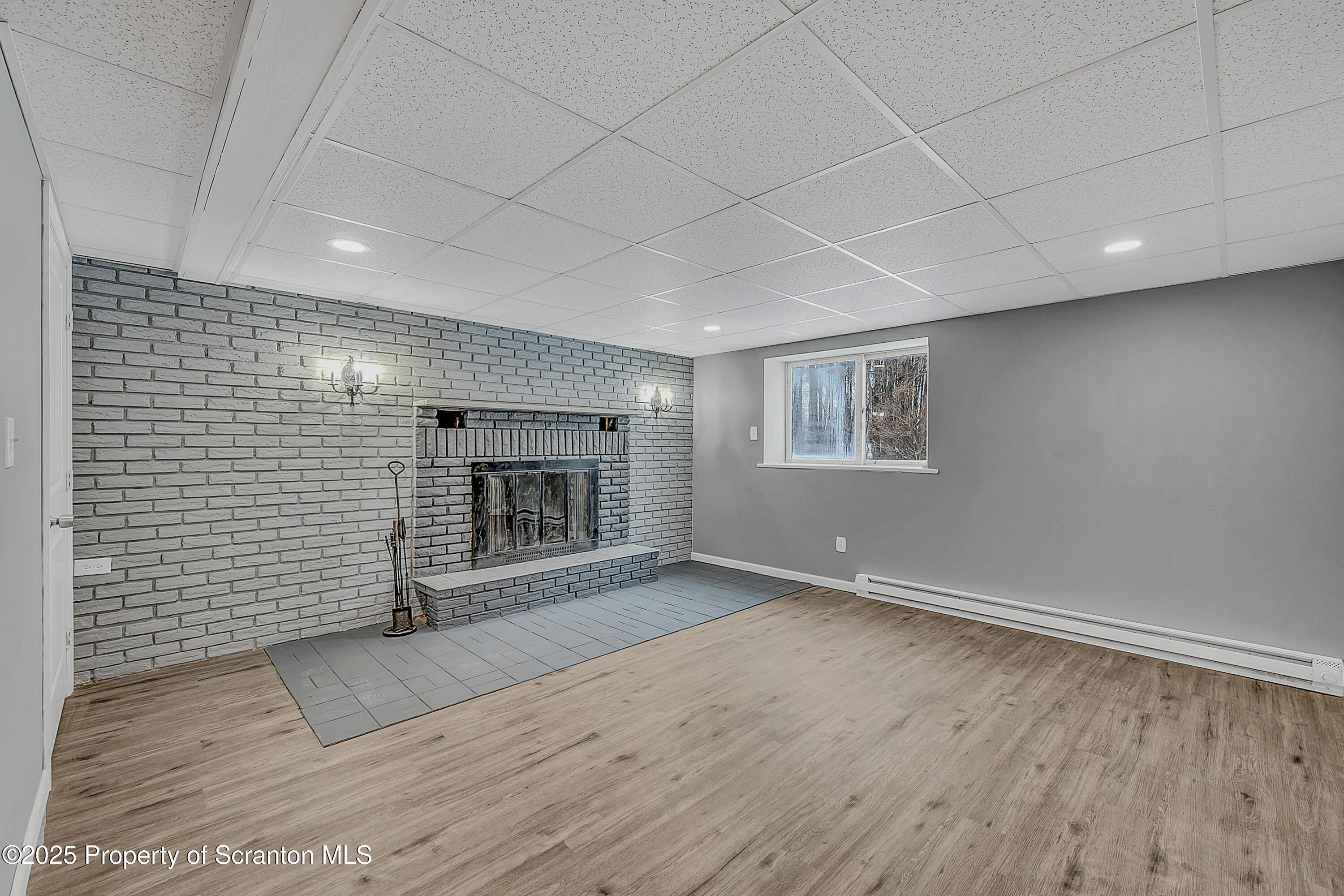 206 Gardner Street Moscow, PA 18444 - Photo 38 of 50 an empty room with wooden floor and fireplace