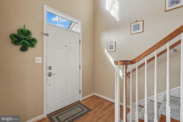 a living room with furniture and a floor to ceiling window next to a large window