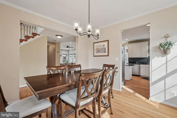 a kitchen with granite countertop a sink stainless steel appliances and white cabinets