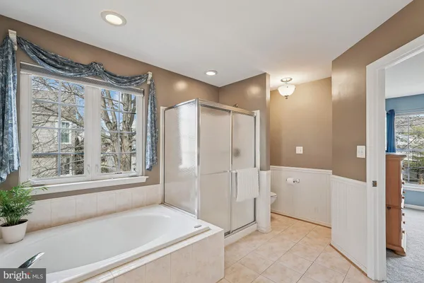a bathroom with a granite countertop sink a large mirror and a toilet