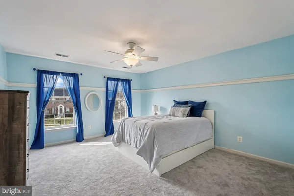 a living room with furniture and a ceiling fan