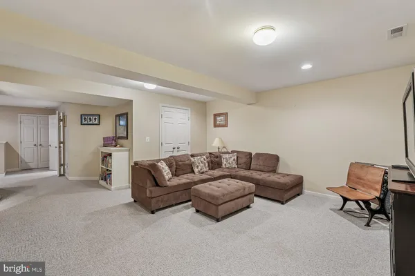 a room with furniture pool table and windows