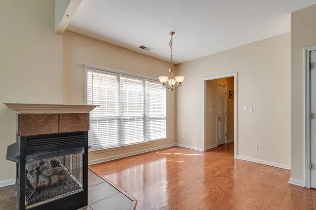 wooden floor in an empty room with a fireplace