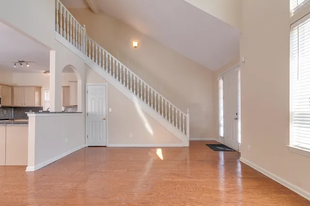 a view of entryway and hall with wooden floor