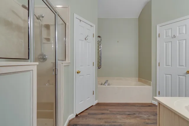 a bathroom with a bathtub and a shower