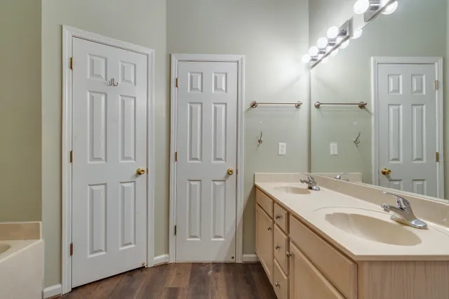 a bathroom with 2 sink and a mirror
