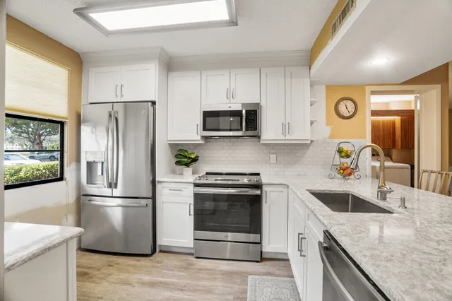 a kitchen with a sink and a refrigerator