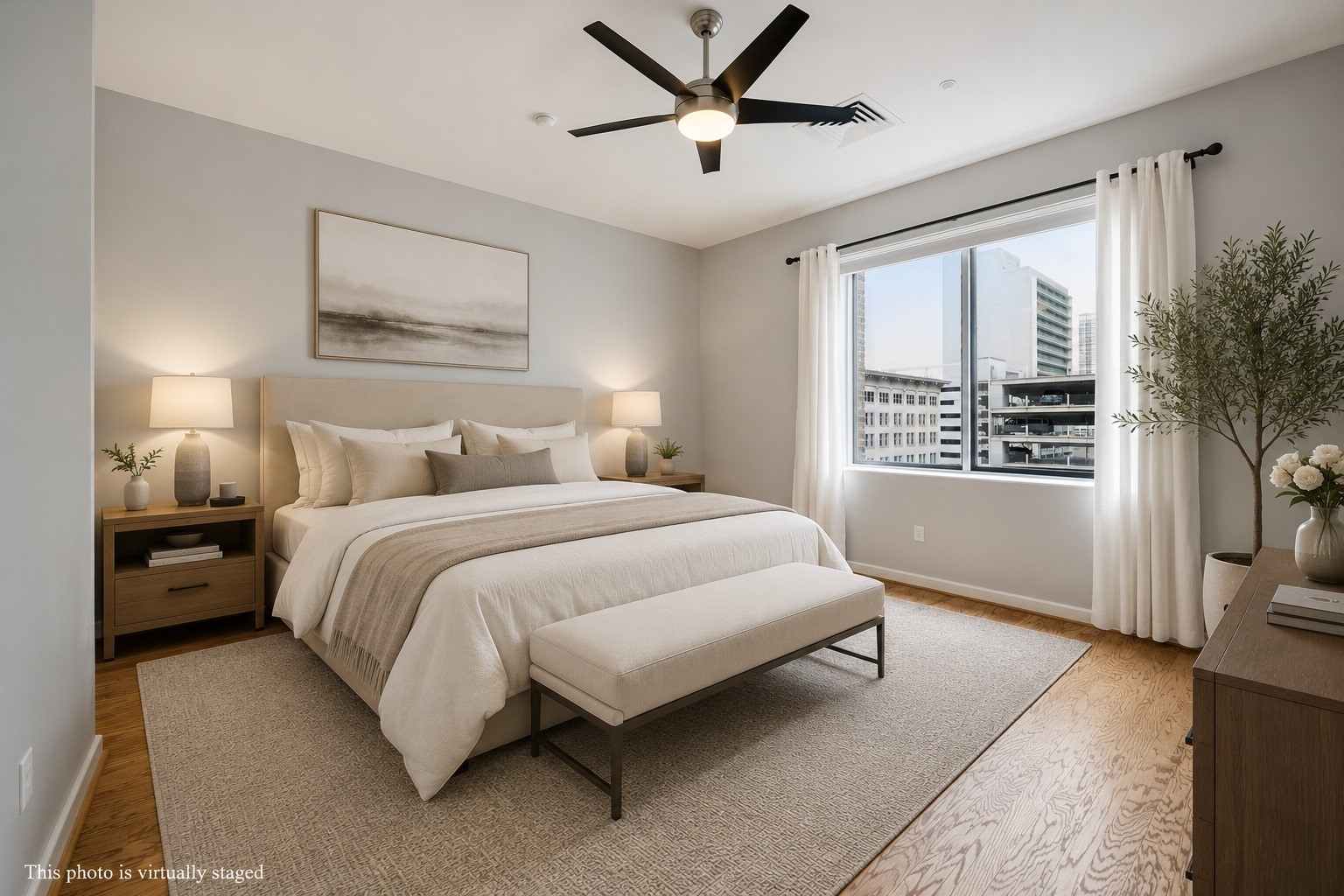 914 Main Street, Unit 910 Houston, TX 77002 - Photo 9 of 32 Virtually staged primary bedroom features a stylish, modern design with neutral tones, a large window offering city views, and ample natural light.