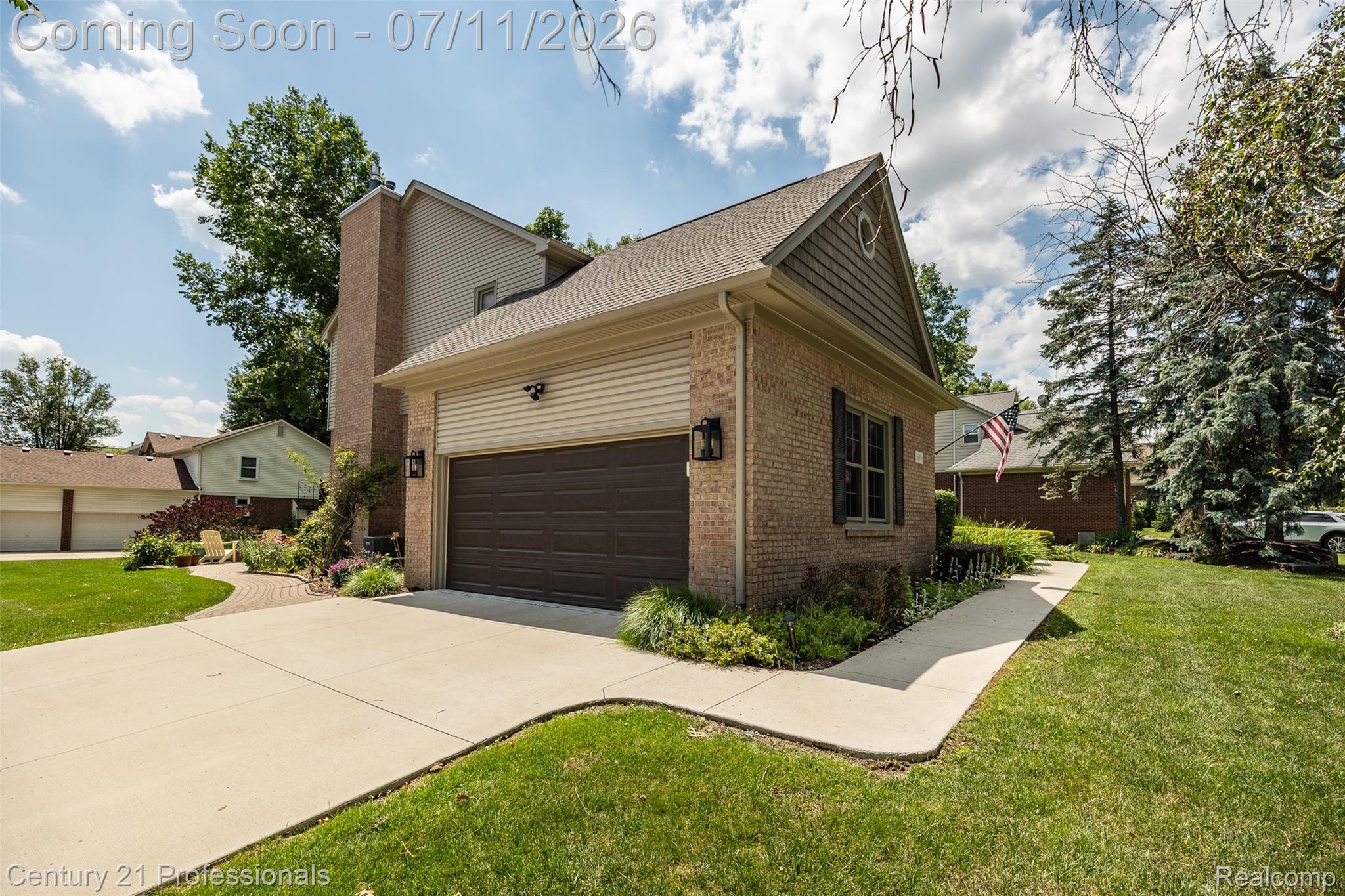 689 Woodfield Way Rochester, MI 48307 - Photo 32 of 61 Brick exterior with attached garage, concrete driveway, and mature landscaping