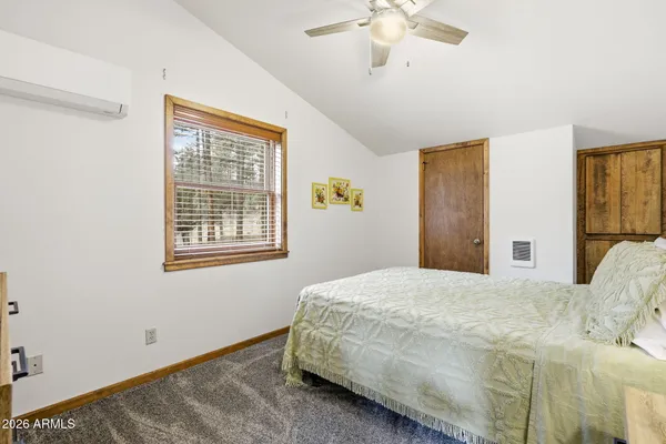 a living room with furniture ceiling fan and a window