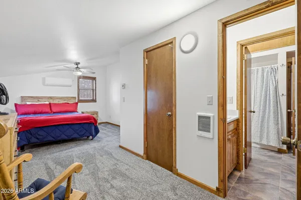 a bedroom with a large bed and a chandelier