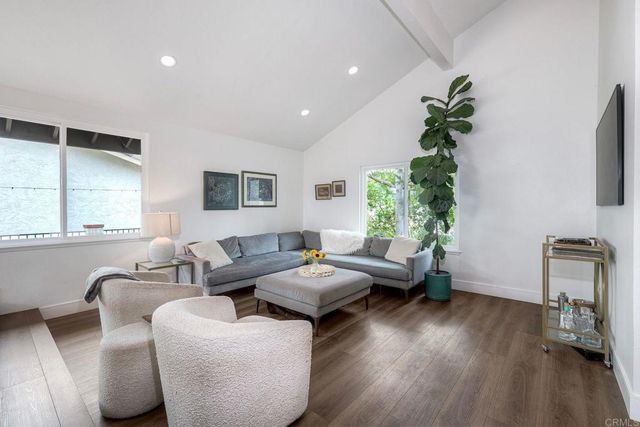 a view of a dining room with furniture wooden floor and chandelier